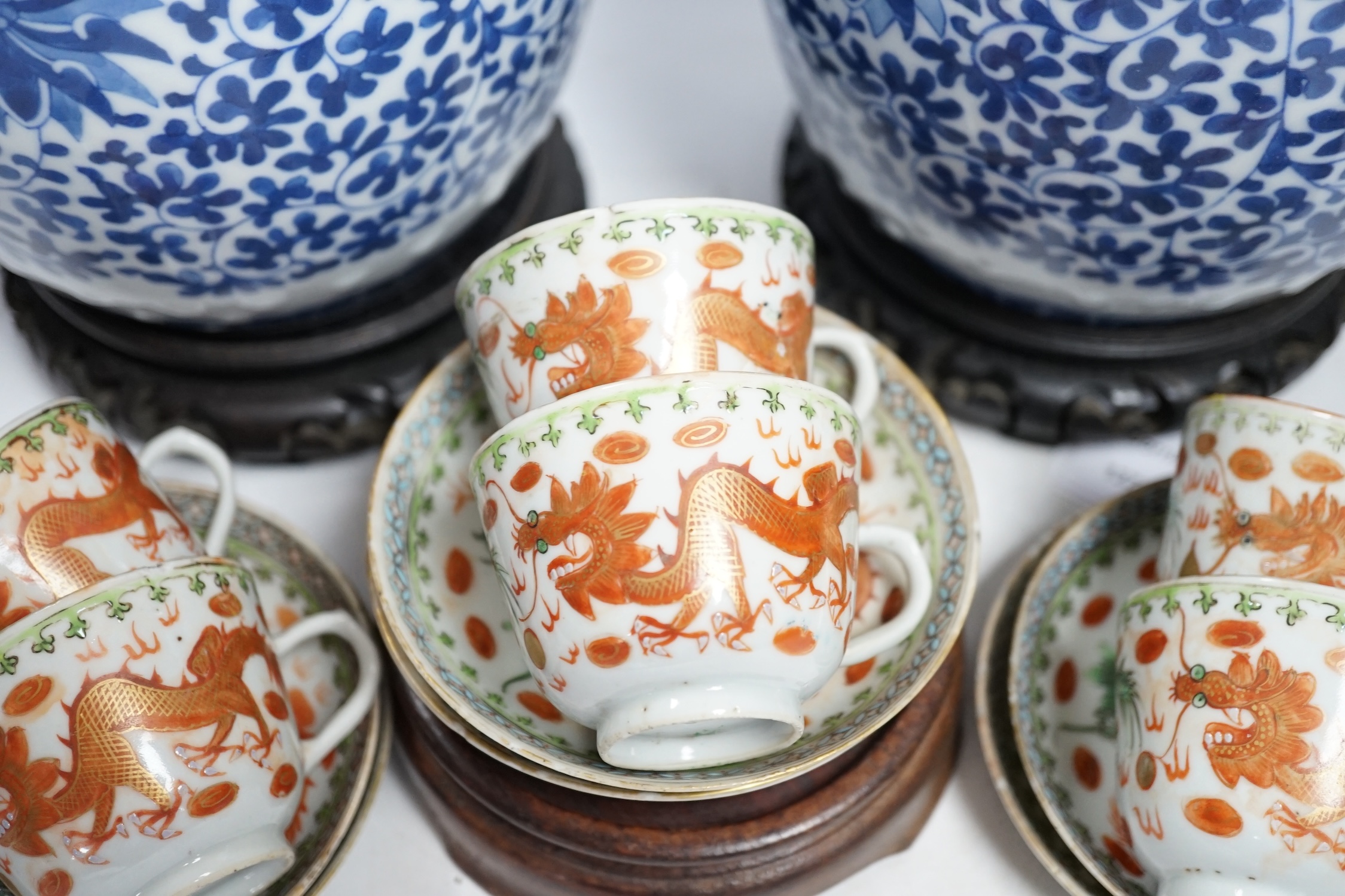 A pair of Chinese blue and white barrel jars, various cups and saucers and three hardwood stands, largest 21cm high